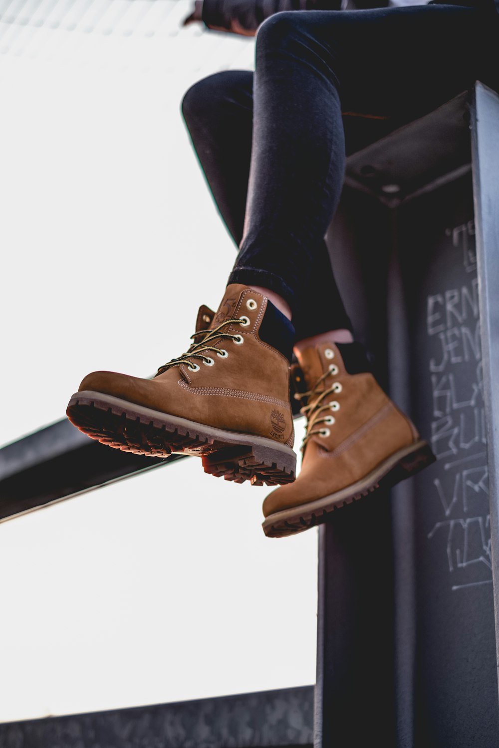 sitting woman wearing black pants and brown work boots