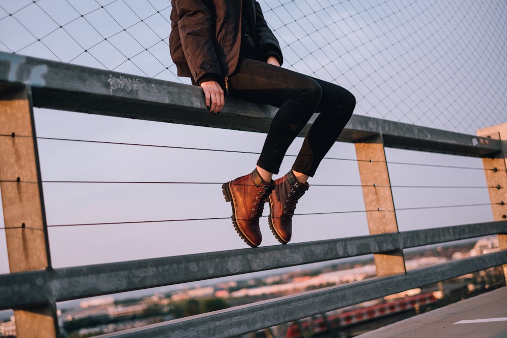 woman sitting on rail