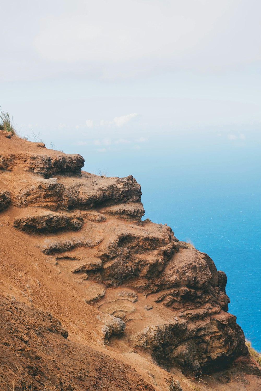 brown mountain with body of water