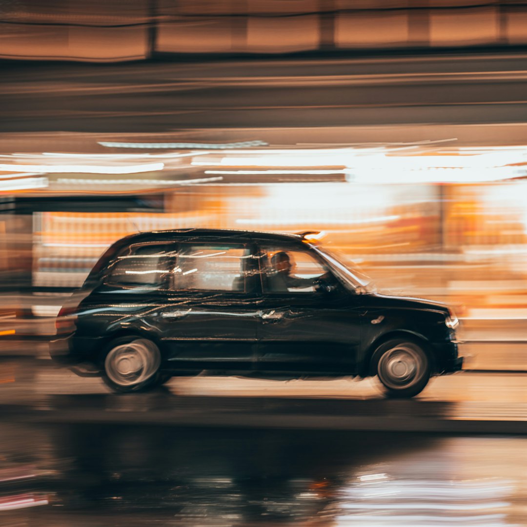 black vehicle running on road