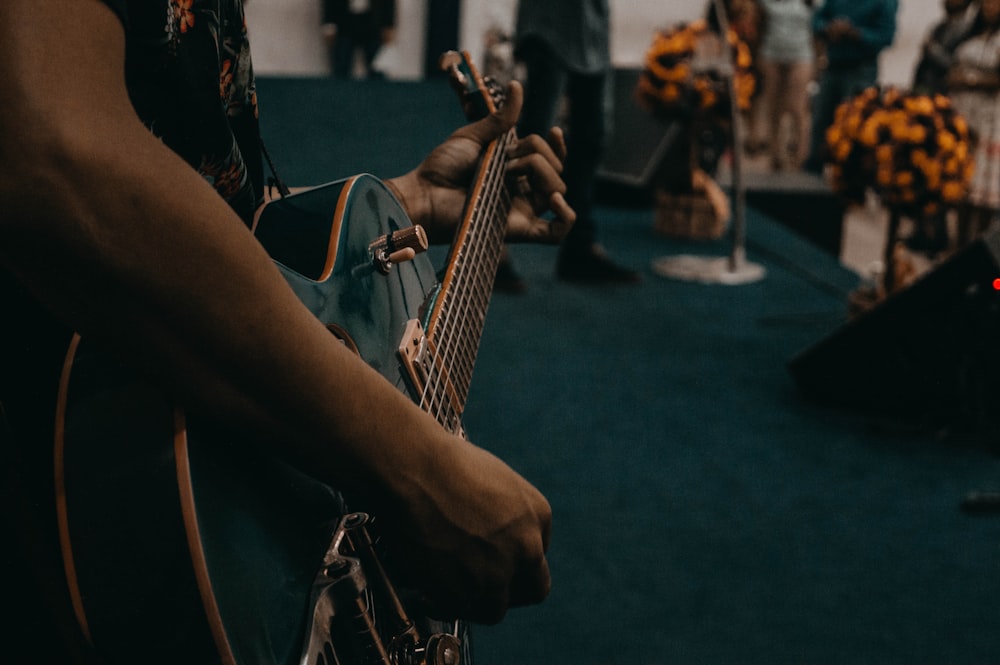 person playing black guitar