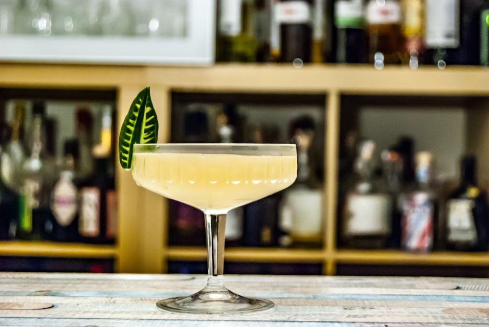 clear martini glass with yellow liquid