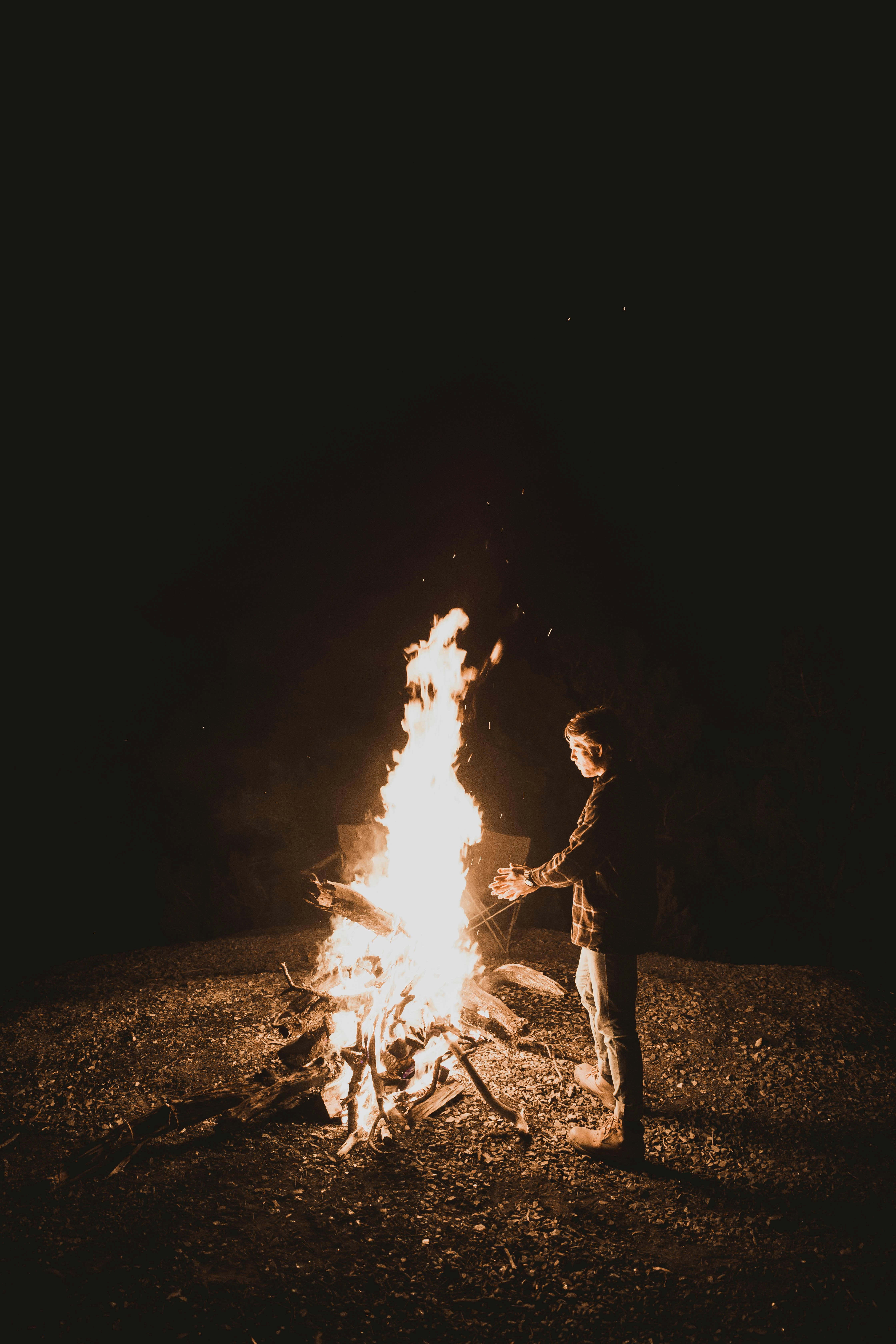 Man Standing Near Fire Pit Photo Free Fire Image On Unsplash