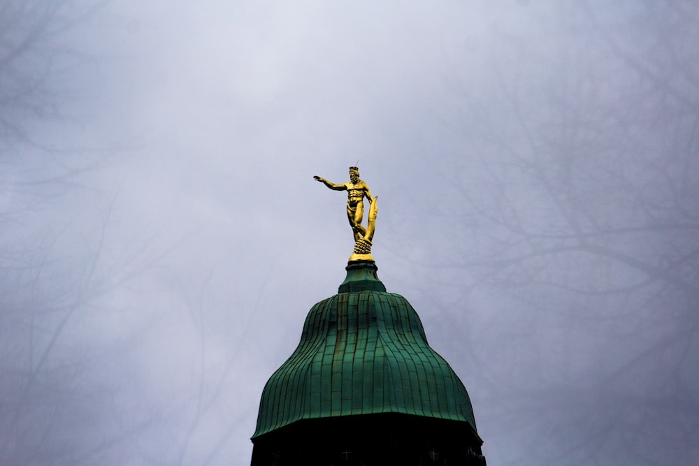 naked man on dome building statue
