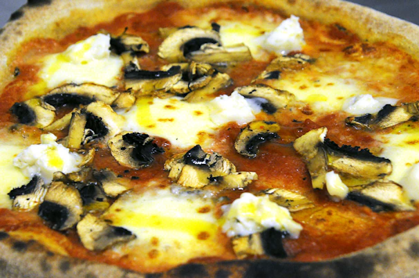 A hot, cheesy muzza pizza fresh out of the oven with bubbling cheese.
