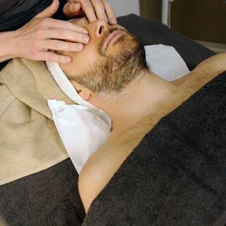 sleeping man while having massage