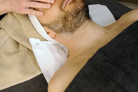 sleeping man while having massage