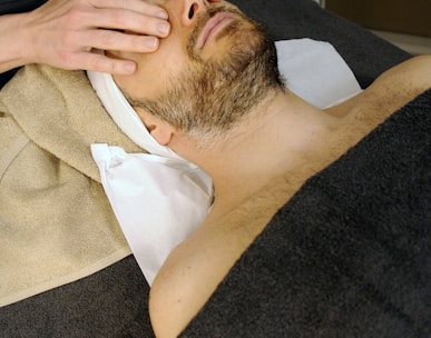 sleeping man while having massage