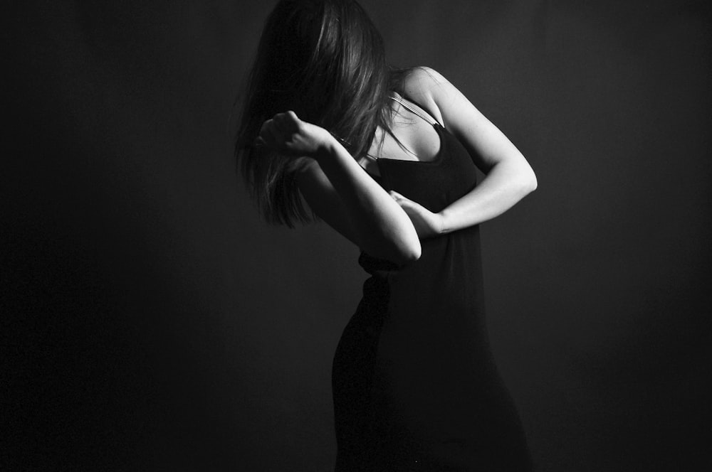 grayscale photography of woman in sleeveless dress