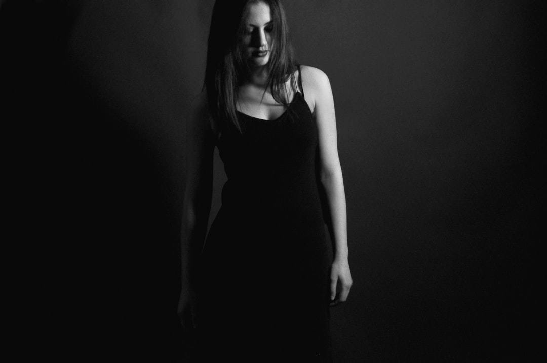 grayscale photography of woman in dress