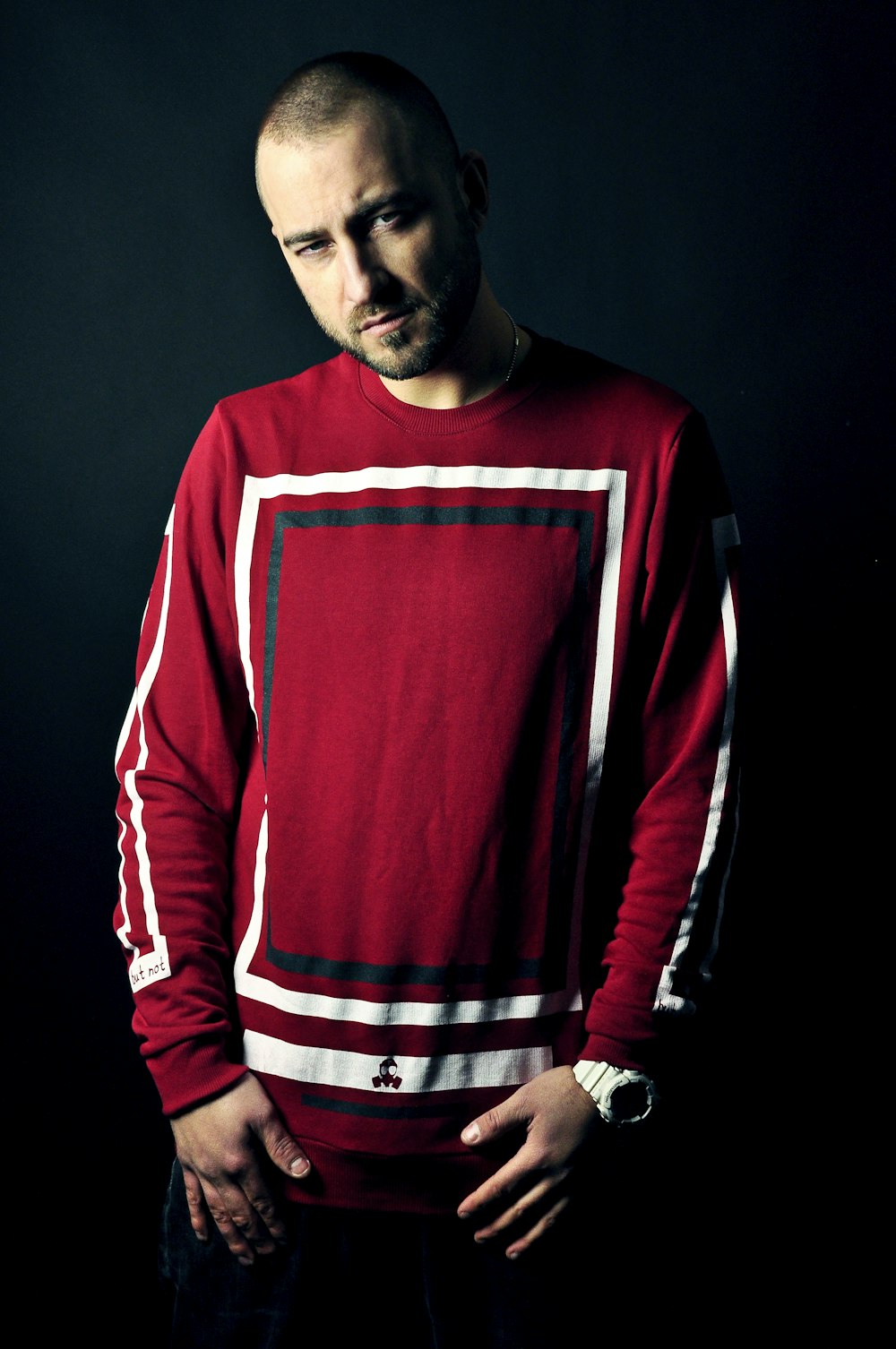 man wearing red and white long-sleeved shirt standing