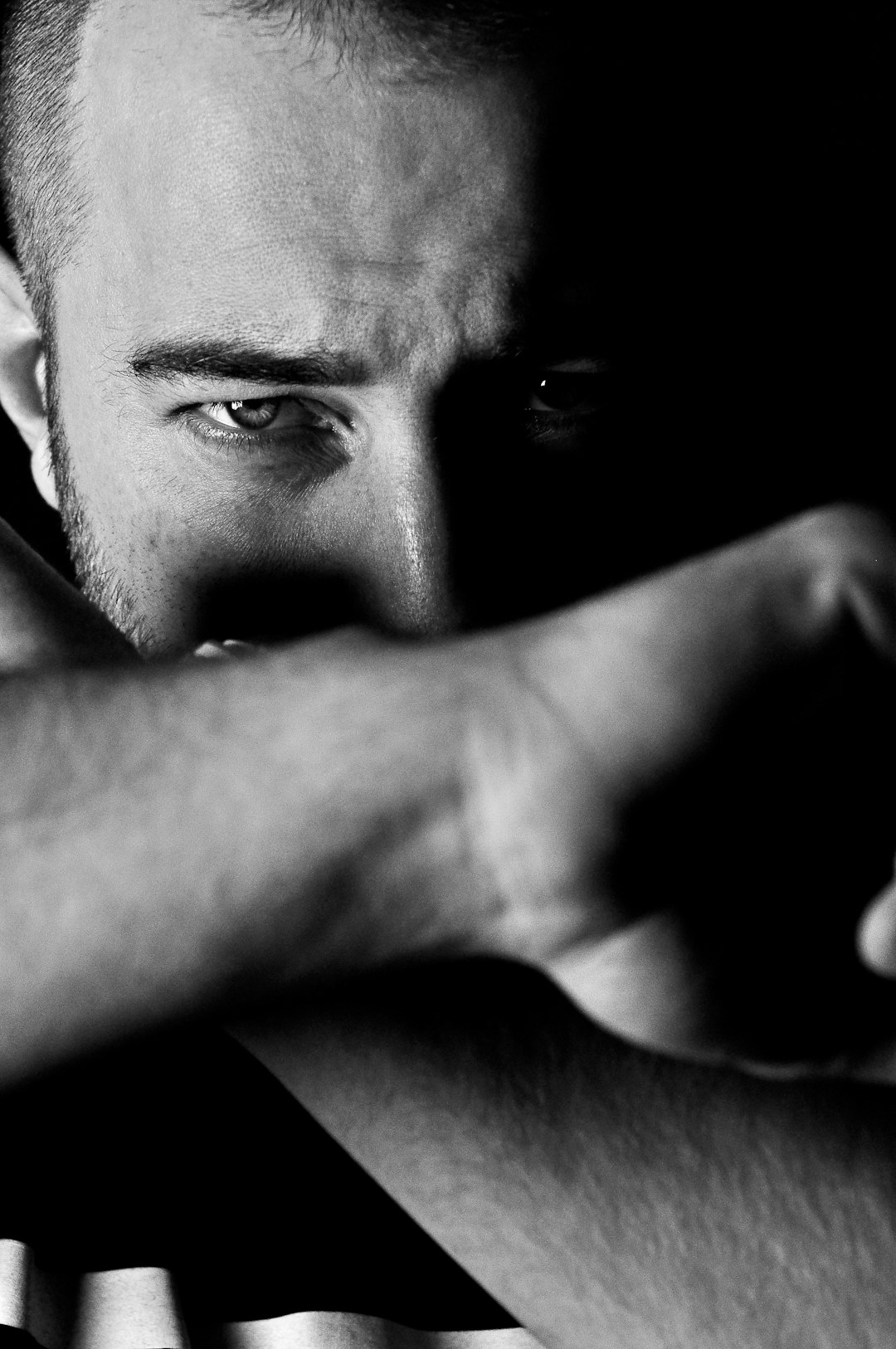 man doing a cross hand sign with his arms