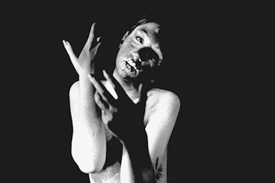 A dramatic scene from a theatrical play captured in black and white.