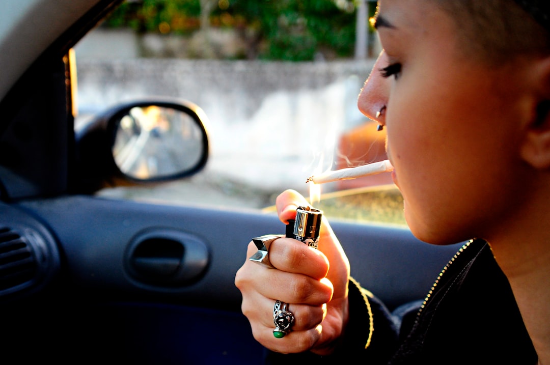 woman lighted cigarette stick inside car
