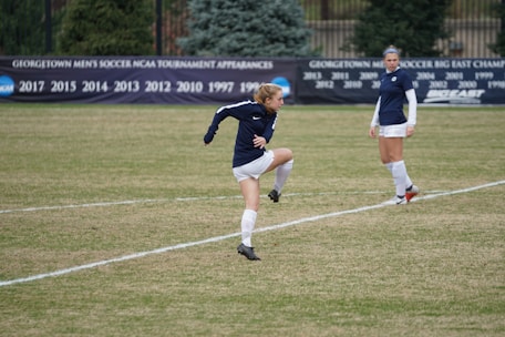 Football players mid-action on a lush green pitch during the festival's annual tournament.