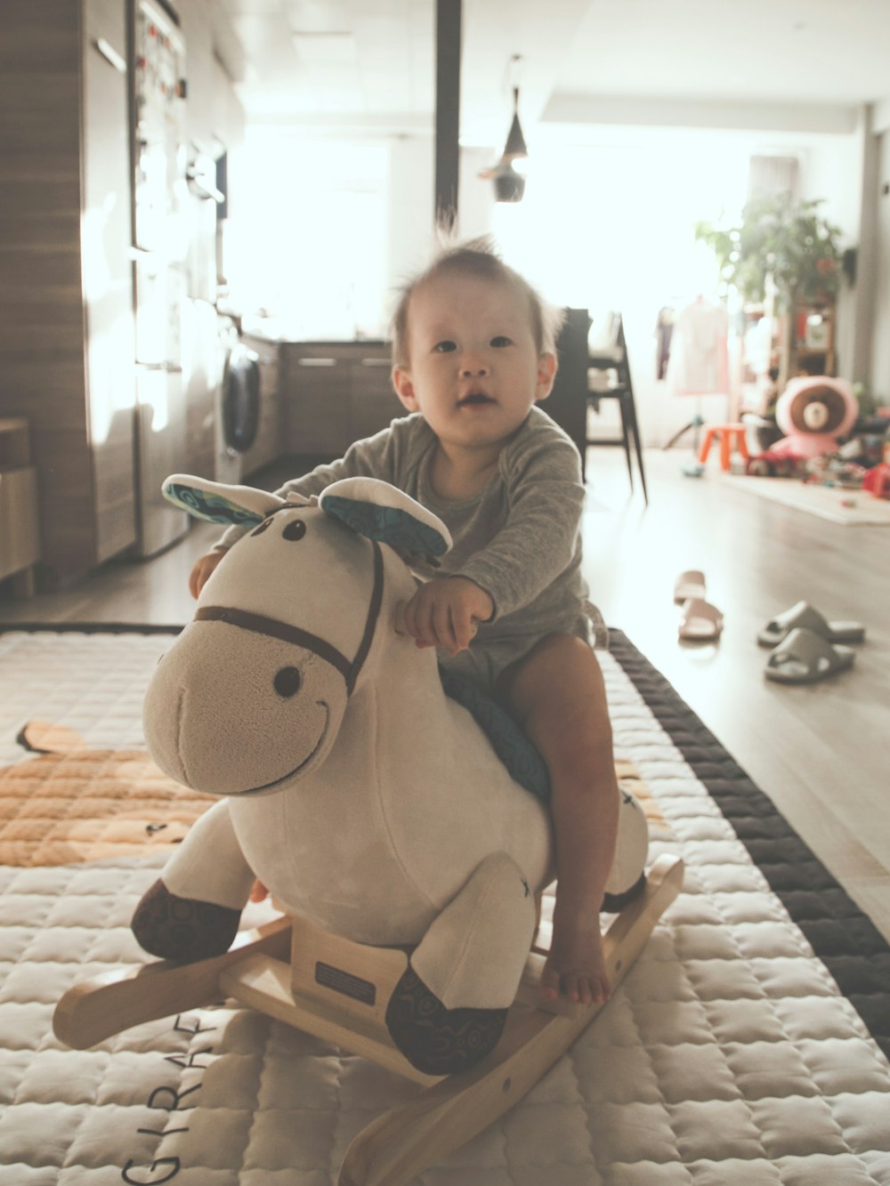 baby riding rocking plush horse