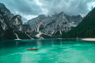 2 person on boat at lake during daytime