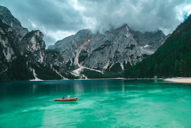2 person on boat at lake during daytime