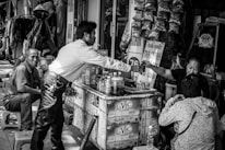 Close-up of hands exchanging money and goods in a casual market environment.