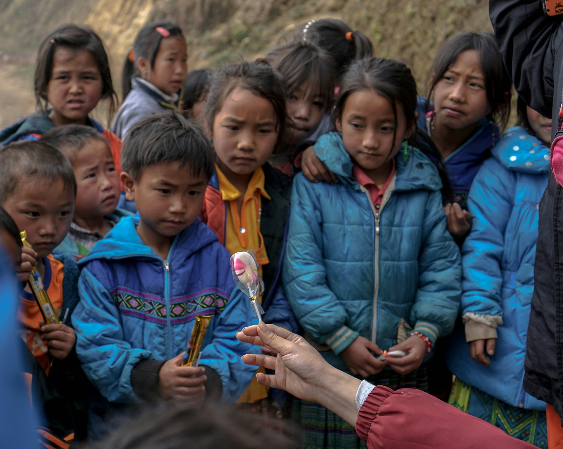 Students gathered around a science experiment, eyes wide with curiosity and excitement.