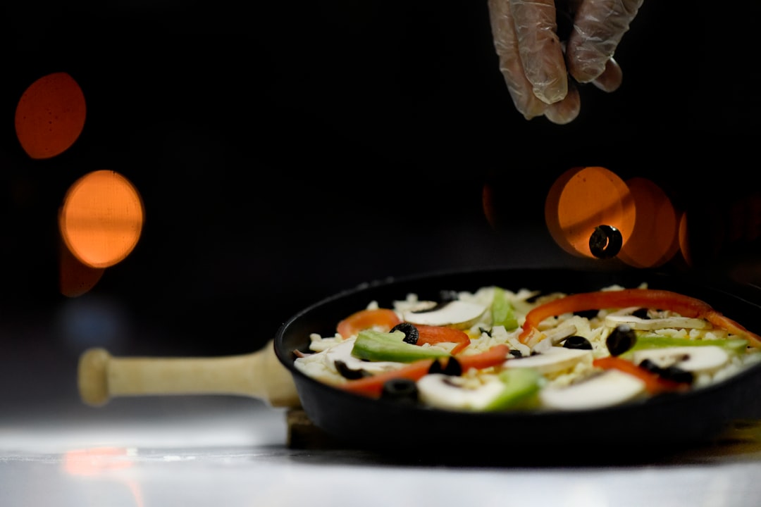 sliced orange and green bell peppers in gray cooking pan