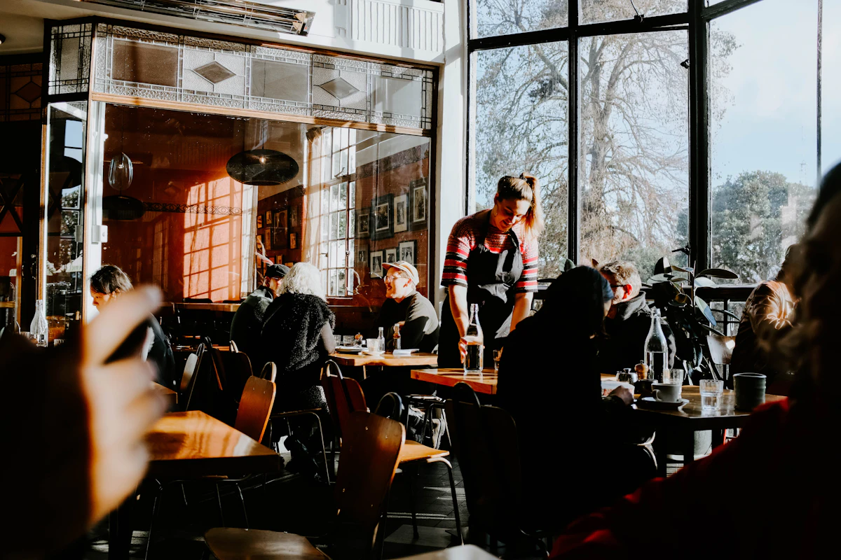 Server working through a busy restaurant dining room