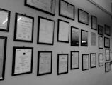 Close-up of medical certificates and awards displayed proudly in the clinic.