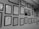 A wall adorned with an array of framed certificates and diplomas, meticulously organized in several rows. The frames are of uniform dark color, contributing to a professional and orderly appearance.
