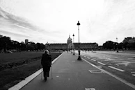 A patient walking confidently with crutches outside the hospital garden, showing progress.