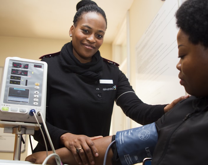 woman having blood pressure monitor