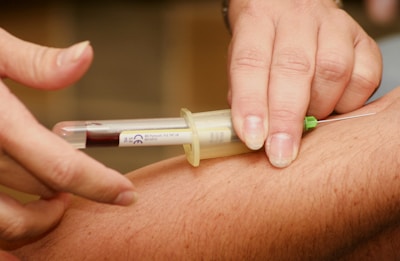 person injecting syringe