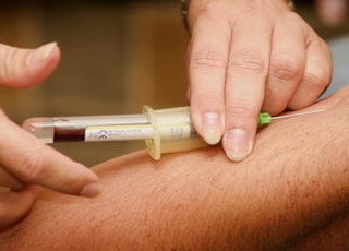 person injecting syringe