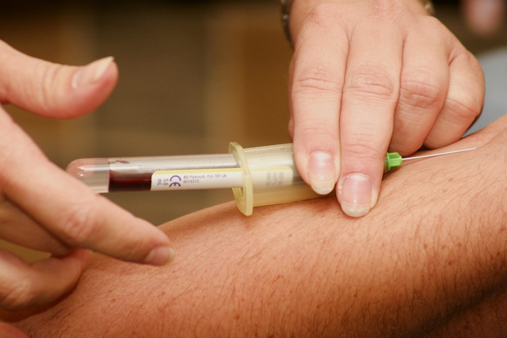 person injecting syringe