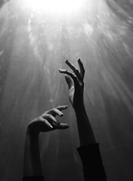 hands reaching up to try and grasp the light of the ineffable 