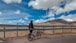 cyclist stop at the road to look at the sky