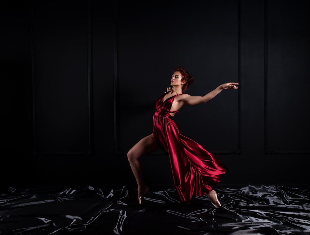 woman wearing red tank satin high slit dress