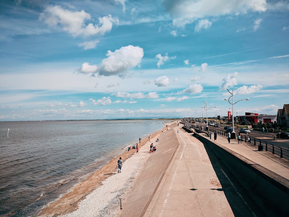 people walking near the beach during daytime