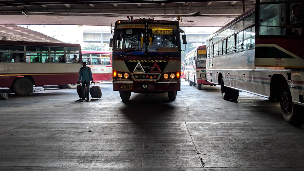 person standing in bus terminal during daytime