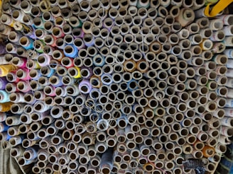 A close-up of colorful yarn spools neatly arranged in a vibrant textile workshop.