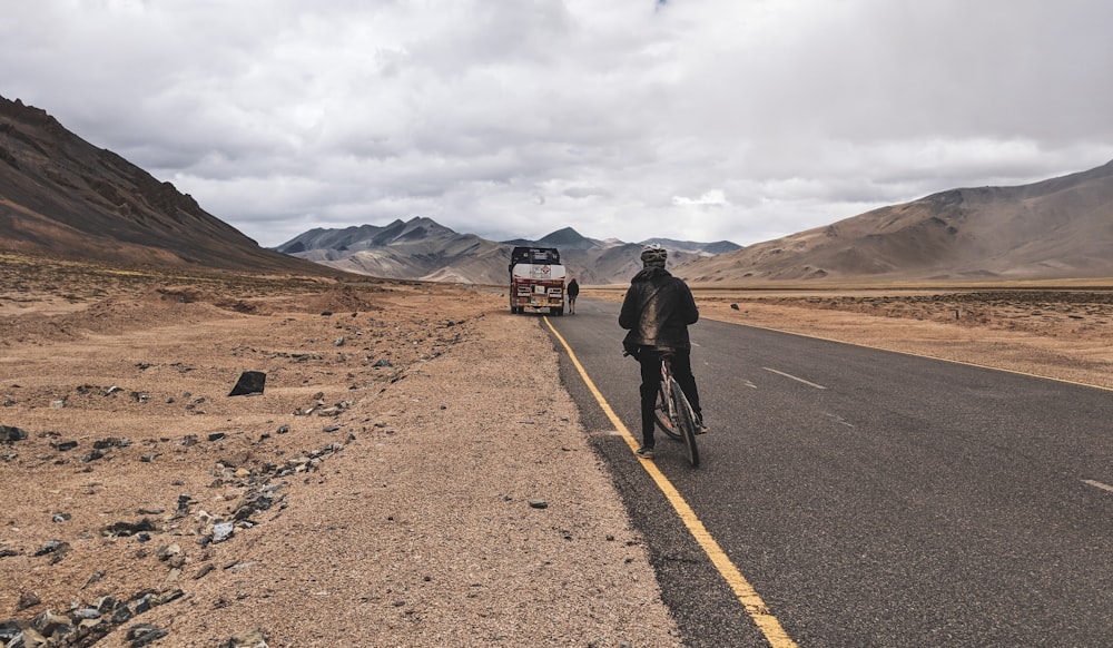 person riding on bicycle on road