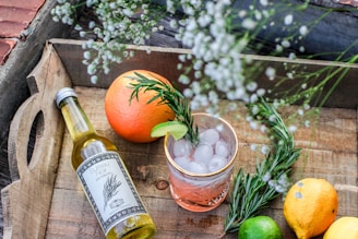 orange fruit beside bottle of drink