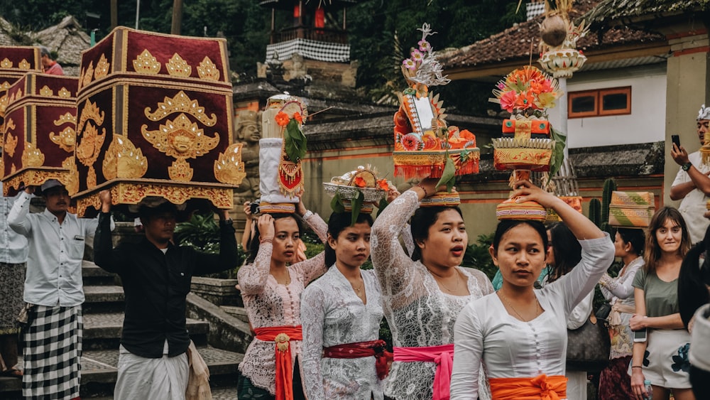 people at ceremony carrying pots