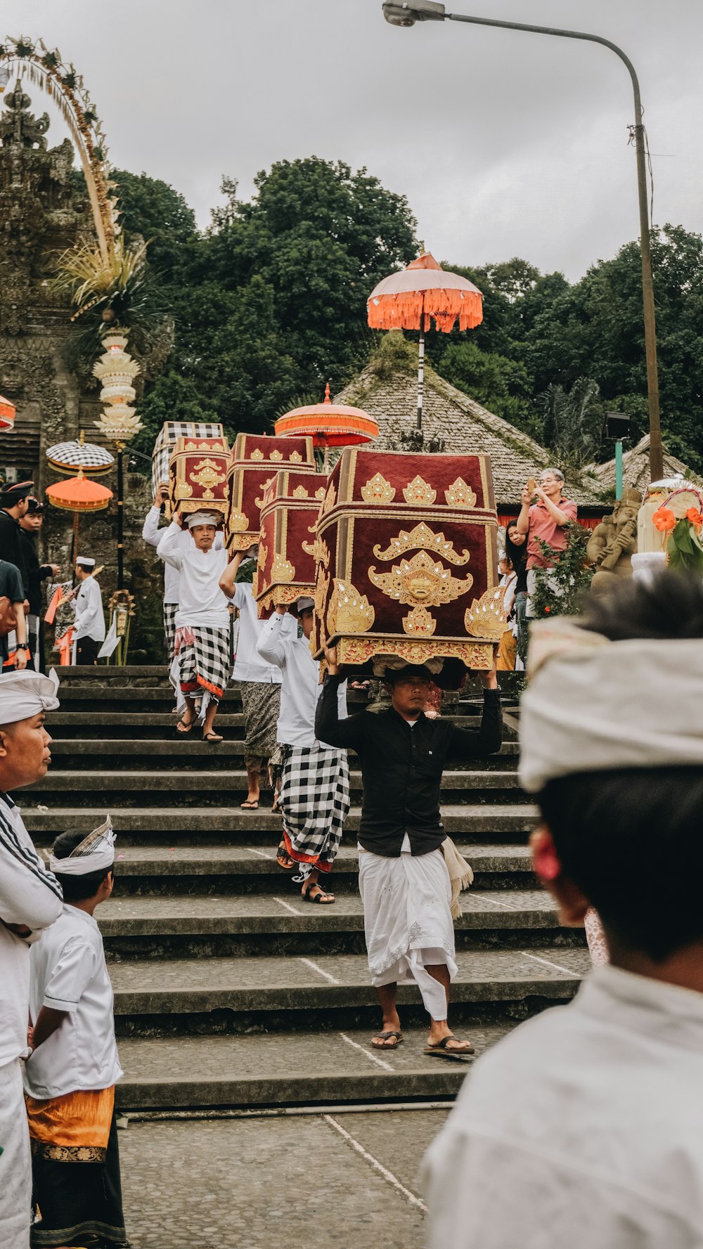 people walking down on stairs carrying altars