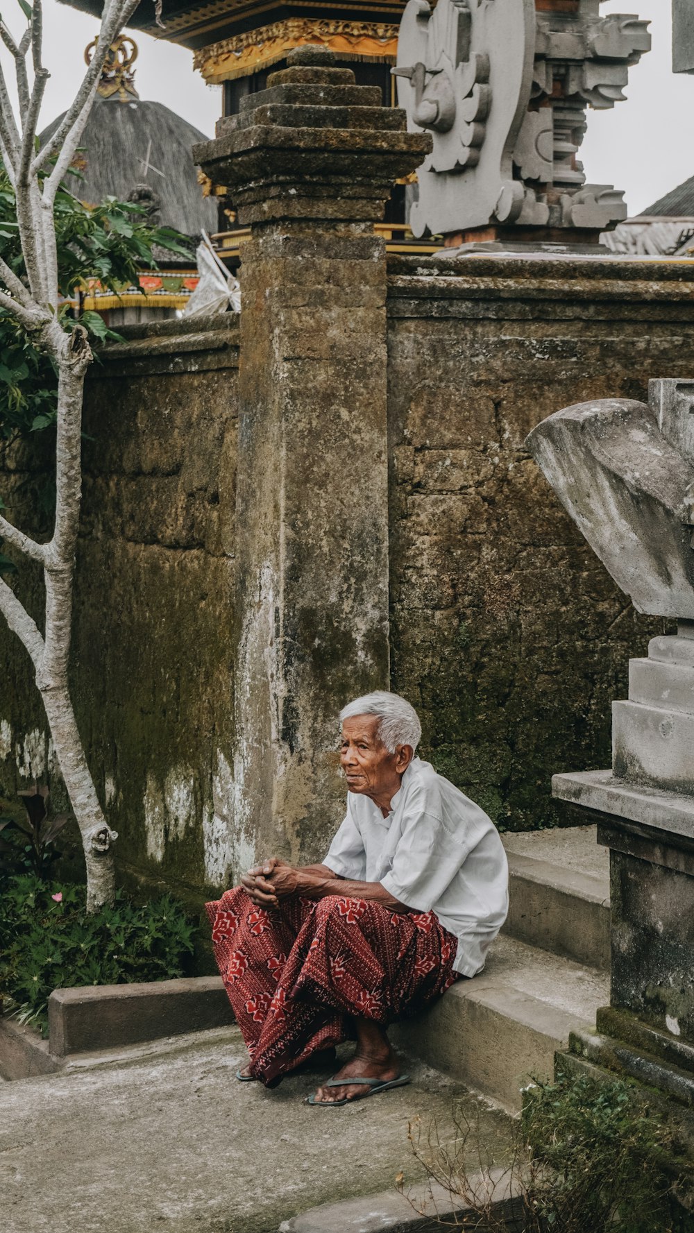 man sitting on stair during daytime