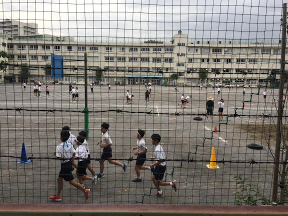 Students playing safely in the outdoor daycare area under supervision.