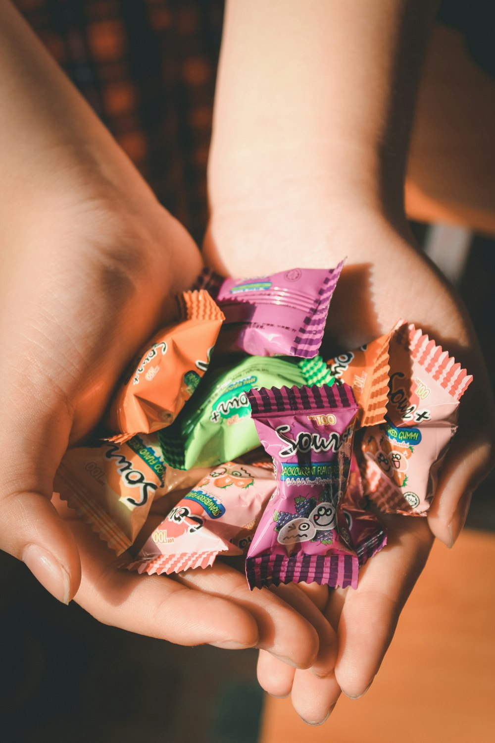 person holding packs of candy
