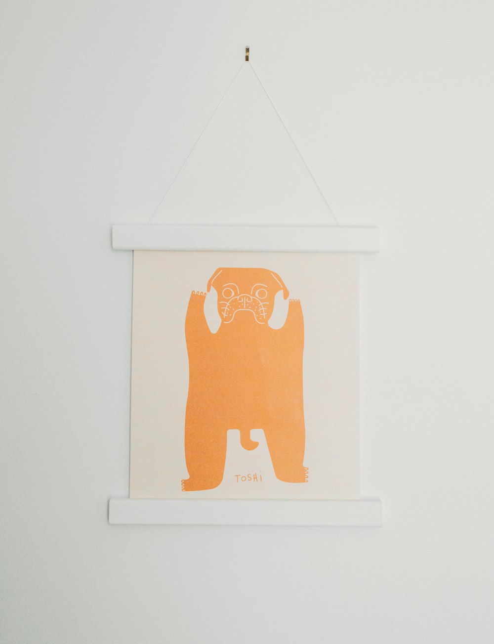 white and orange dog wall decor