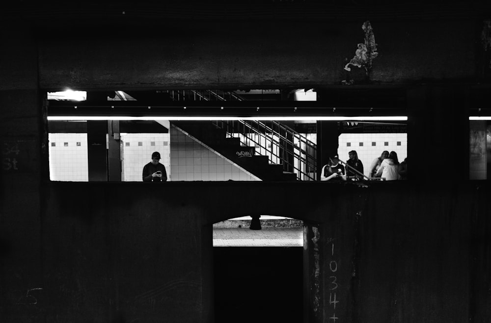 grayscale photography of people inside building
