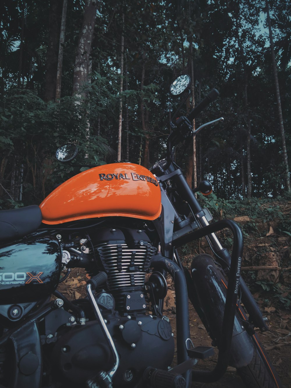 black and orange Royal Enfield motorcycle during daytime