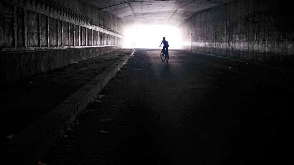 silhouette photography of person riding bicycle